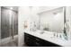 Stylish bathroom with double sinks, a sleek vanity, and a walk-in shower with glass door at 14454 Grape Way, Brighton, CO 80602