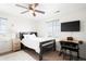 Neutral bedroom featuring a ceiling fan, TV, and plenty of natural light at 14454 Grape Way, Brighton, CO 80602