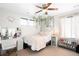 Bright bedroom with a plush pink throw blanket, accented with unique wall décor at 14454 Grape Way, Brighton, CO 80602