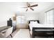 Bright bedroom with neutral colors, a ceiling fan, and dual windows for natural light at 14454 Grape Way, Brighton, CO 80602