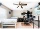 Spacious bedroom with a ceiling fan, a large bed, and a functional workspace at 14454 Grape Way, Brighton, CO 80602