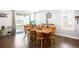 Dining room with a long wood table and seating for ten with windows providing ample natural light at 14454 Grape Way, Brighton, CO 80602