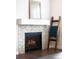 Close up of the fireplace with a herringbone tile surround and mantle at 14454 Grape Way, Brighton, CO 80602
