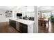 Bright, open kitchen flows into the living and dining areas, featuring a large island and modern finishes at 14454 Grape Way, Brighton, CO 80602