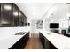 Elegant kitchen open to the living room featuring stainless appliances and long countertops at 14454 Grape Way, Brighton, CO 80602