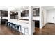 Stylish kitchen with dark cabinetry, stainless steel appliances, and a spacious island with bar seating at 14454 Grape Way, Brighton, CO 80602