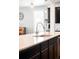 Bright kitchen island boasts stainless steel faucet, undermount sink, and modern pendant lighting at 14454 Grape Way, Brighton, CO 80602
