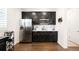 Modern kitchen with stainless steel appliances and dark cabinets features plenty of counter space at 14454 Grape Way, Brighton, CO 80602