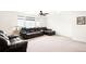 Spacious living room with ceiling fan, neutral carpet and leather furniture at 14454 Grape Way, Brighton, CO 80602