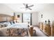 Spacious main bedroom with ceiling fan, balcony access, and a large dresser offers plenty of room at 14454 Grape Way, Brighton, CO 80602