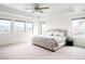 Spacious main bedroom with tray ceilings, ceiling fan, lots of natural light and neutral decor at 14454 Grape Way, Brighton, CO 80602