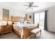 Spacious main bedroom with ceiling fan, balcony access, and a large dresser offers plenty of room at 14454 Grape Way, Brighton, CO 80602