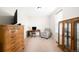 Office space with a wooden desk and chair, dresser and a comfortable armchair offers a workspace at 14454 Grape Way, Brighton, CO 80602