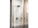 Close up of frameless glass shower with rainfall showerhead, a built in niche and grey tiling at 14454 Grape Way, Brighton, CO 80602
