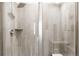 Modern shower features stylish tile work, a rainfall showerhead, and a glass enclosure at 14454 Grape Way, Brighton, CO 80602