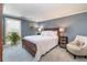 Cozy bedroom with soft carpet, a cushioned chair, and lots of natural light from the window at 130 N Pearl St # 808, Denver, CO 80203