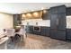 A modern kitchen features dark wood cabinetry, stainless steel appliances, and a dining area at 130 N Pearl St # 808, Denver, CO 80203
