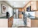 Modern kitchen with stainless steel appliances, tile backsplash, and wooden cabinets at 130 N Pearl St # 808, Denver, CO 80203