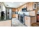 Kitchen featuring stainless steel appliances, granite countertops and wood cabinets at 130 N Pearl St # 808, Denver, CO 80203