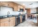 Kitchen featuring stainless steel appliances, double sink, wood cabinetry and granite countertops at 130 N Pearl St # 808, Denver, CO 80203