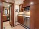 Kitchenette featuring wood cabinets, stainless steel appliances and granite countertops at 130 N Pearl St # 808, Denver, CO 80203