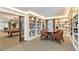 A cozy library features built-in bookshelves, a round table with seating, and is adjacent to the billiards room at 130 N Pearl St # 808, Denver, CO 80203
