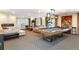 An expansive living room with a fireplace, modern decor, and a pool table for entertainment at 130 N Pearl St # 808, Denver, CO 80203