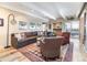 Cozy living room with a large sectional sofa, decorative rug, and access to the outdoor balcony at 130 N Pearl St # 808, Denver, CO 80203