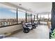 Bright living area with stunning city views from large windows and two comfortable leather chairs at 130 N Pearl St # 808, Denver, CO 80203