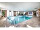 Bright indoor pool area featuring brick accents, tiled floors, and a serene swimming space at 130 N Pearl St # 808, Denver, CO 80203