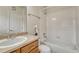 Neat bathroom, featuring a shower/tub combo and wood vanity at 16700 Las Ramblas Ln # O, Parker, CO 80134