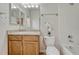 Clean bathroom with a tub, toilet, and vanity with wooden cabinets at 16700 Las Ramblas Ln # O, Parker, CO 80134