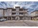 Three-story building with multiple attached garages and balconies at 16700 Las Ramblas Ln # O, Parker, CO 80134