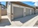 Attached garage with gray doors and stone accents at 16700 Las Ramblas Ln # O, Parker, CO 80134