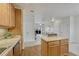 Eat-in kitchen with island and view to living room at 16700 Las Ramblas Ln # O, Parker, CO 80134