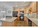 Modern kitchen with wood cabinetry and center island at 16700 Las Ramblas Ln # O, Parker, CO 80134