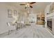 Cozy living room featuring neutral carpet, fireplace, ceiling fan, and open concept design at 16700 Las Ramblas Ln # O, Parker, CO 80134