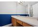 Bathroom boasts an extended counter with a large mirror and half wall accent at 338 Chelsea St, Castle Rock, CO 80104