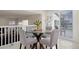 Cozy dining area with a glass table, seating for four, and natural light from sliding glass doors at 338 Chelsea St, Castle Rock, CO 80104
