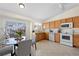 Bright kitchen with stainless steel appliances, tile flooring, and a cozy dining area at 338 Chelsea St, Castle Rock, CO 80104