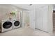 A modern washer and dryer are ready to serve in the laundry area next to the downstairs bathroom with glass shower at 338 Chelsea St, Castle Rock, CO 80104
