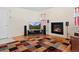 Living room features a fireplace, hardwood floors, and a flat screen television at 338 Chelsea St, Castle Rock, CO 80104