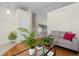 Bright living room adjacent to stairway and featuring hardwood floors, contemporary furniture, and plants at 338 Chelsea St, Castle Rock, CO 80104