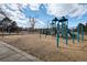 Community playground featuring modern blue and green equipment on a wood chip ground cover at 338 Chelsea St, Castle Rock, CO 80104