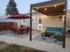 Inviting backyard patio with comfortable seating, dining area, string lights and stylish outdoor rug at 11 S Perry St, Denver, CO 80219