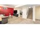 Cozy basement living area with carpet, television and doorway to a home gym at 11 S Perry St, Denver, CO 80219