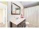 Bathroom with a single sink vanity, large mirror, and shower-tub combo at 11 S Perry St, Denver, CO 80219