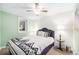 Cozy bedroom with neutral walls and a double bed, decorated with patterned pillows and blanket at 11 S Perry St, Denver, CO 80219