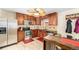 Well-lit kitchen features stainless steel appliances, granite countertops, and wooden cabinetry at 11 S Perry St, Denver, CO 80219