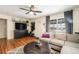 Cozy living room featuring hardwood floors, a large window, comfortable seating, and ceiling fan at 11 S Perry St, Denver, CO 80219